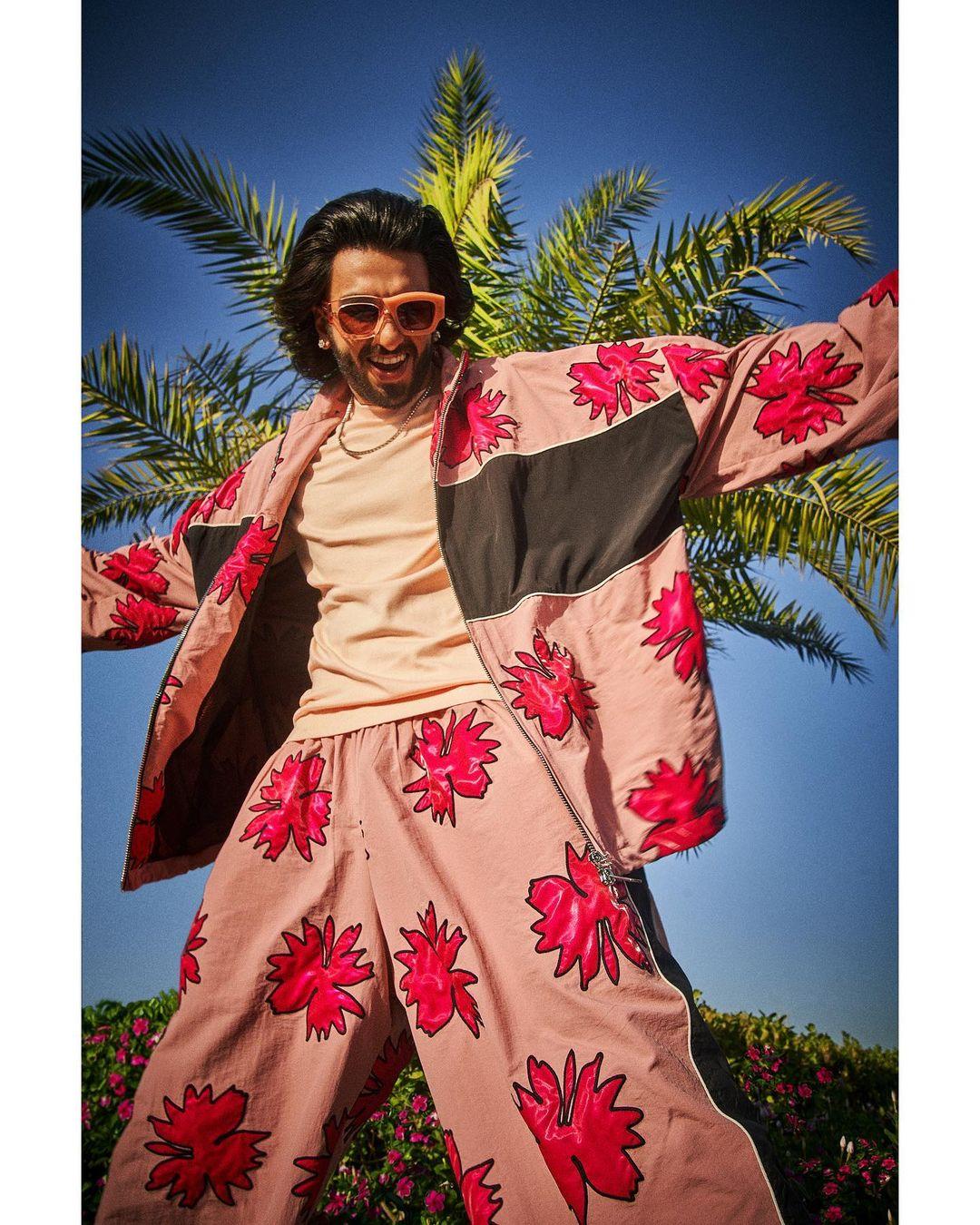 He paired it with a vibrant pink t-shirt and accessorized with statement glasses in the same hue